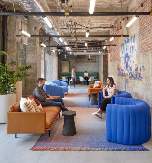 Modern office lounge with chatting coworkers